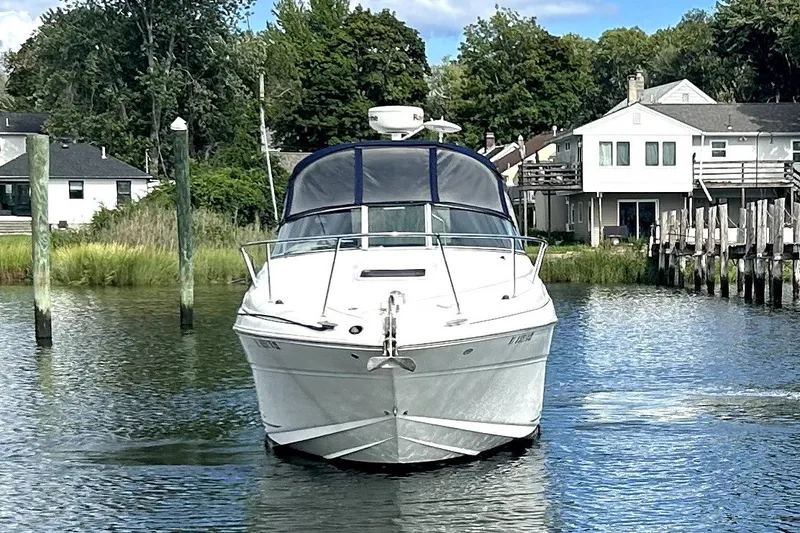 Slide: The Image of 2006 Sea Ray Sundancer 280 boat docked in a serene waterfront setting. - 3