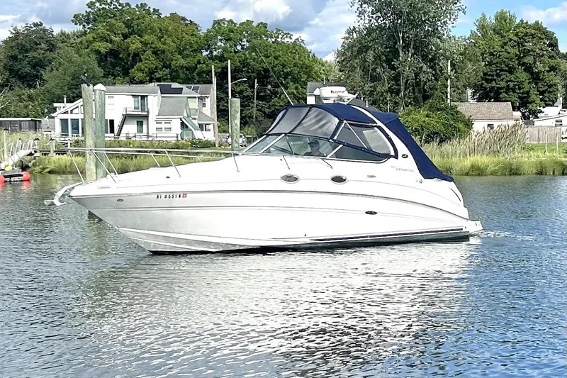 Slide: The Image of 2006 Sea Ray Sundancer 280 cruising on a calm river near a residential area. - 1