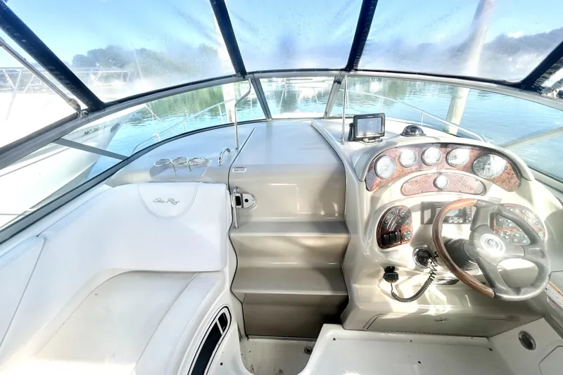 Slide: The Image of Interior cockpit of 2006 Sea Ray Sundancer 280 with steering wheel and dashboard controls. - 11