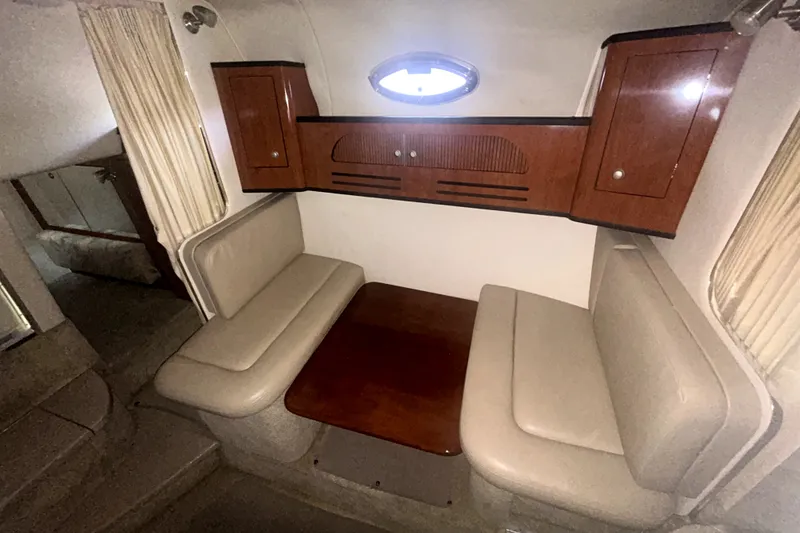 Slide: The Image of 2006 Sea Ray Sundancer 280 cabin interior with seating and wooden table. - 17