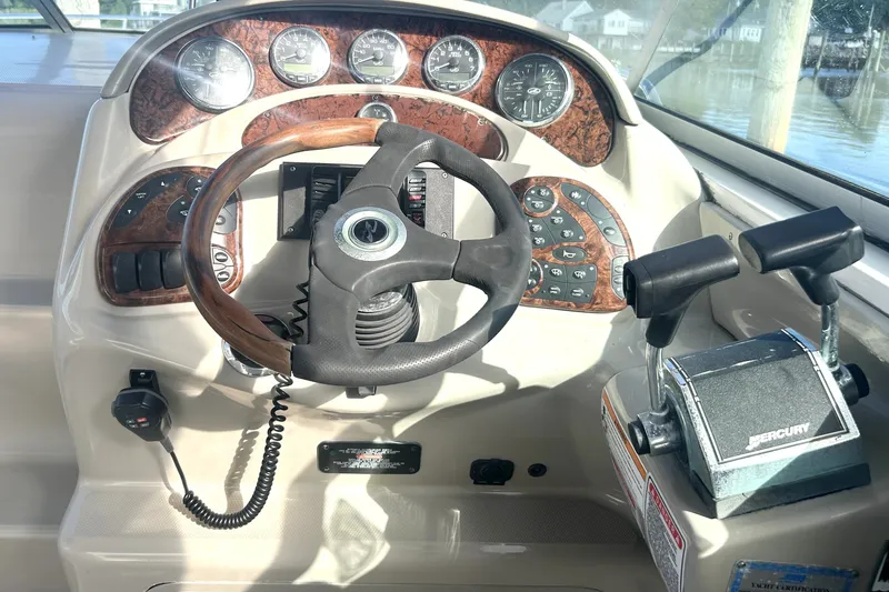 Slide: The Image of Helm of 2006 Sea Ray Sundancer 280 with steering wheel and Mercury controls. - 12