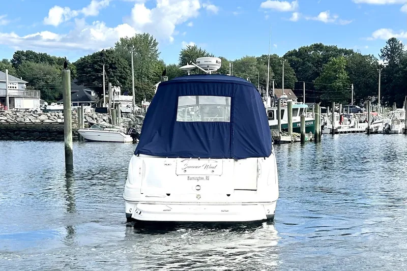 Slide: The Image of 2006 Sea Ray Sundancer 280 boat docked in a marina under a blue sky. - 9