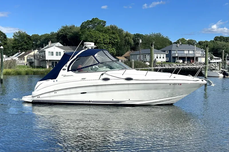 Slide: The Image of 2006 Sea Ray Sundancer 280 cruising on a calm lake near waterfront homes. - 6