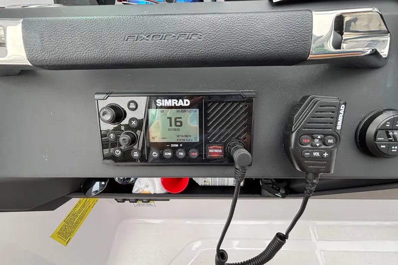 Slide: The Image of Simrad marine radio on 2025 Axopar 29 XC Cross Cabin dashboard. - 18