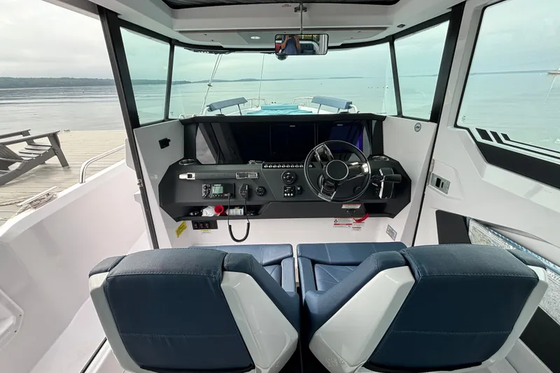 Slide: The Image of Interior view of 2025 Axopar 29 XC Cross Cabin boat with modern helm and seating. - 14