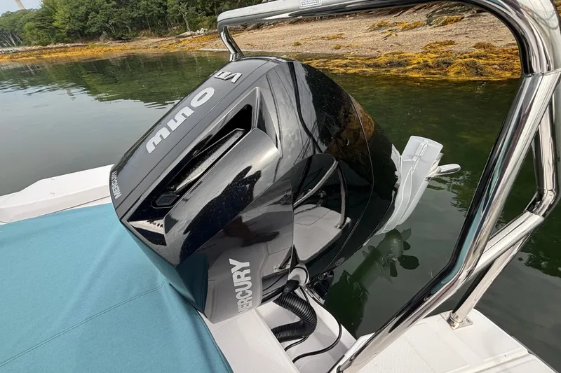 Slide: The Image of 2025 Axopar 29 XC Cross Cabin with Mercury outboard motor on calm water. - 23