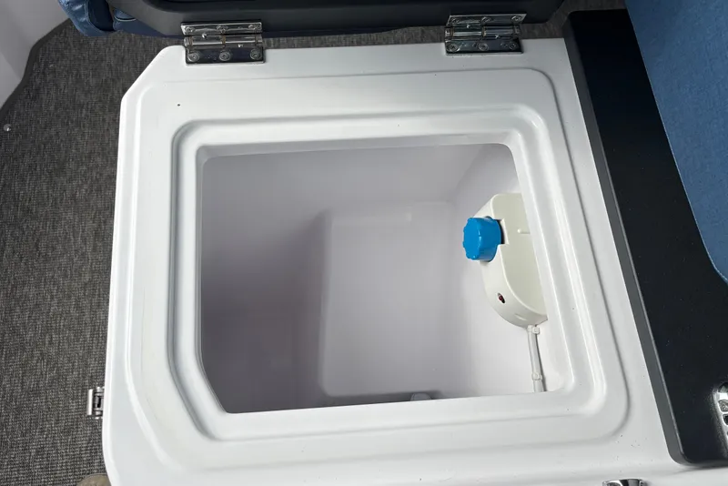 Slide: The Image of Open storage compartment in 2025 Axopar 29 XC Cross Cabin boat interior. - 26