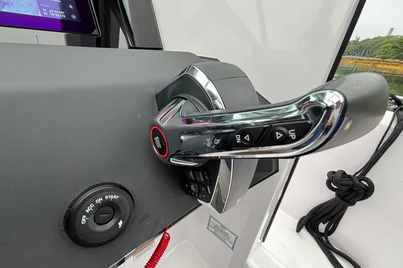Slide: The Image of Throttle control of 2025 Axopar 29 XC Cross Cabin boat, featuring start button and navigation controls. - 16