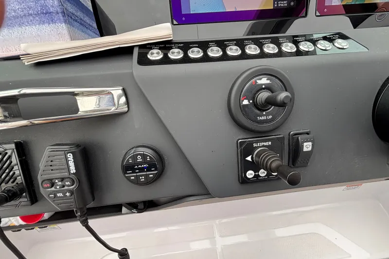 Slide: The Image of Control panel of 2025 Axopar 29 XC Cross Cabin with navigation and audio controls. - 17