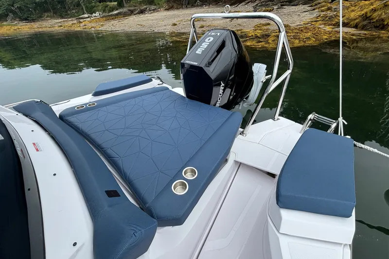 Slide: The Image of 2025 Axopar 29 XC Cross Cabin boat with blue seating and Mercury engine. - 43