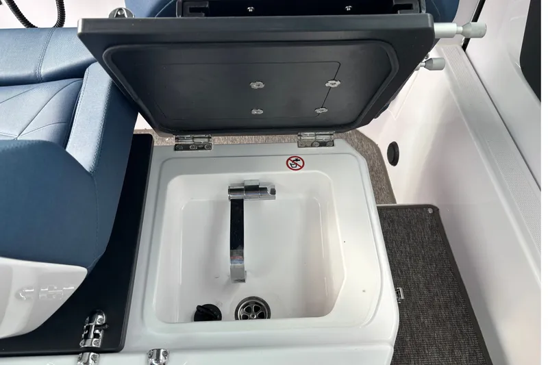 Slide: The Image of Open storage compartment in 2025 Axopar 29 XC Cross Cabin boat interior. - 27