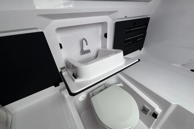 Slide: The Image of 2025 Axopar 29 XC Cross Cabin interior with sink and toilet. - 35