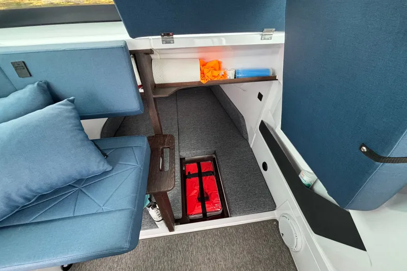 Slide: The Image of Interior of 2025 Axopar 29 XC Cross Cabin with blue seating and storage compartments. - 33
