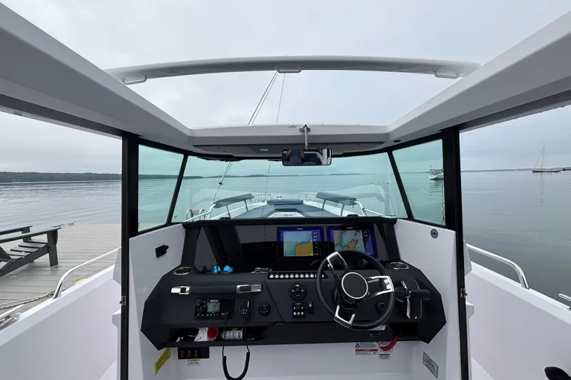 Slide: The Image of Interior view of 2025 Axopar 29 XC Cross Cabin boat with modern dashboard and steering. - 15