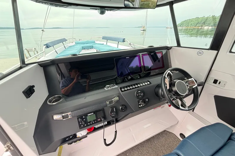 Slide: The Image of Interior view of 2025 Axopar 29 XC Cross Cabin boat cockpit with modern controls. - 13