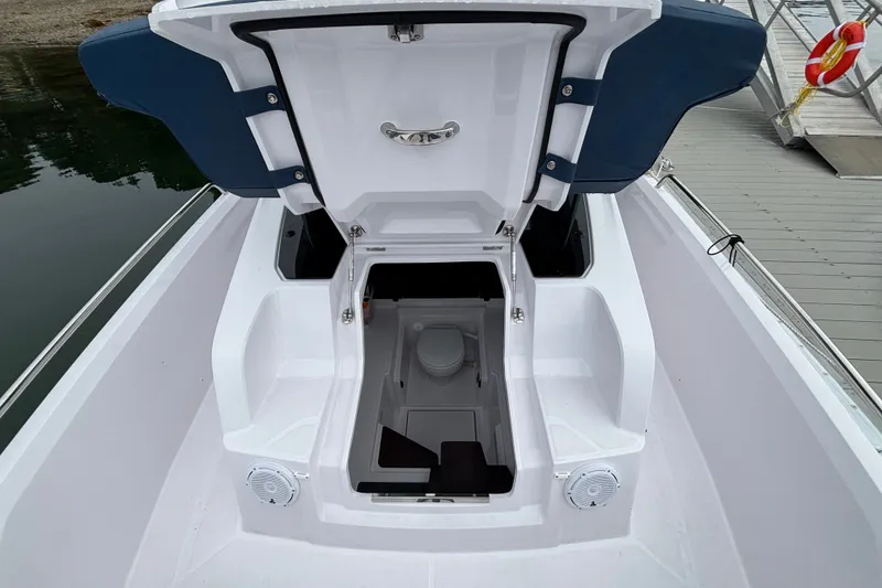 Slide: The Image of 2025 Axopar 29 XC Cross Cabin boat with open storage compartment on deck. - 37