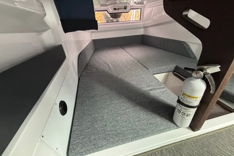 Slide: The Image of Interior cabin of 2025 Axopar 29 XC Cross Cabin with seating and fire extinguisher. - 29