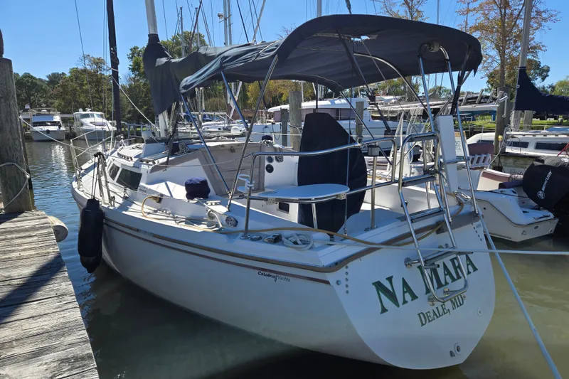 The Image of 1989 Catalina 34 sailboat docked at marina, featuring a sleek design and covered cockpit. - 0