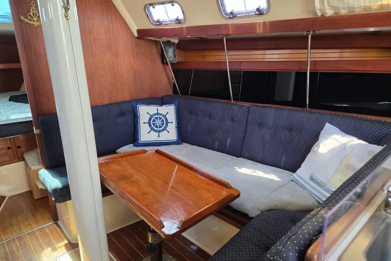 Slide: The Image of Interior of a 1989 Catalina 34 sailboat with cozy seating and nautical decor. - 12