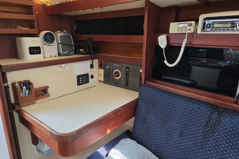 Slide: The Image of Navigation station inside a 1989 Catalina 34 sailboat with radio and control panel. - 15
