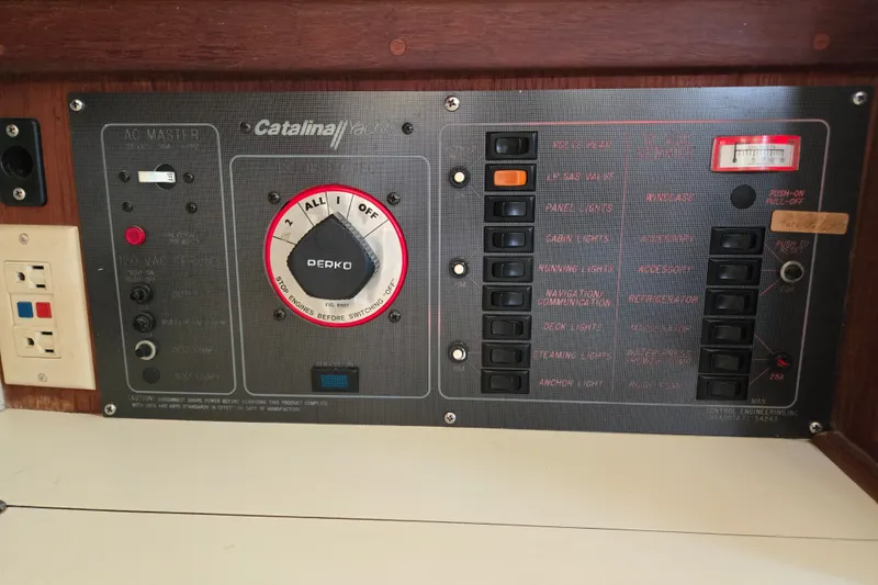 Slide: The Image of Electrical control panel of a 1989 Catalina 34 sailboat with switches and outlets. - 16