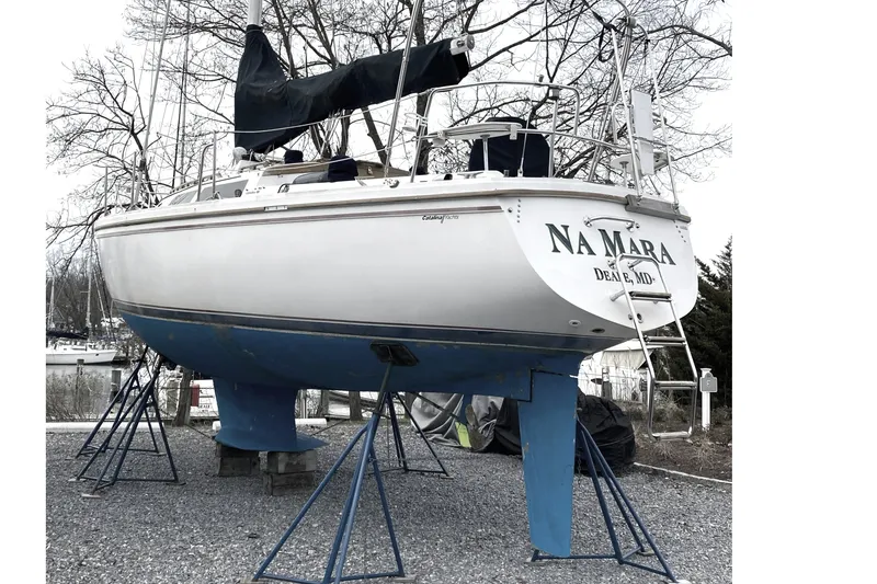 Slide: The Image of 1989 Catalina 34 sailboat on stands, named "Na Mara," located in Deale, MD. - 36