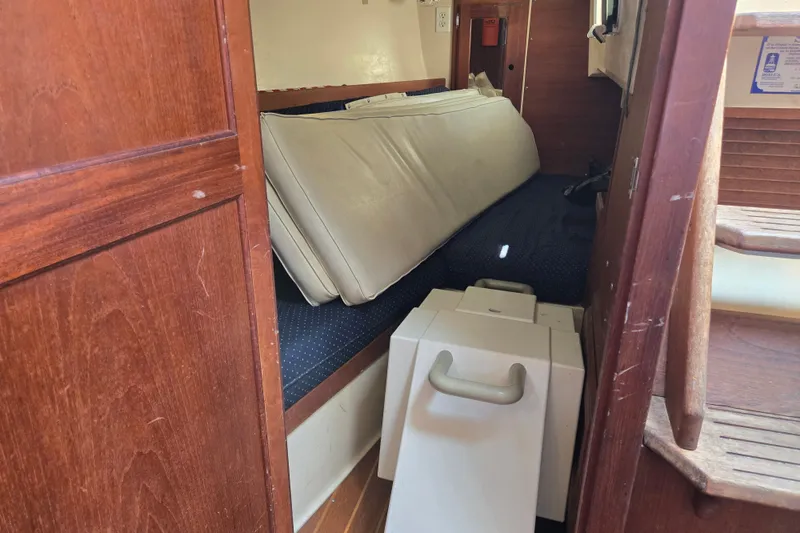 Slide: The Image of Interior cabin of a 1989 Catalina 34 sailboat with cushions and storage. - 28