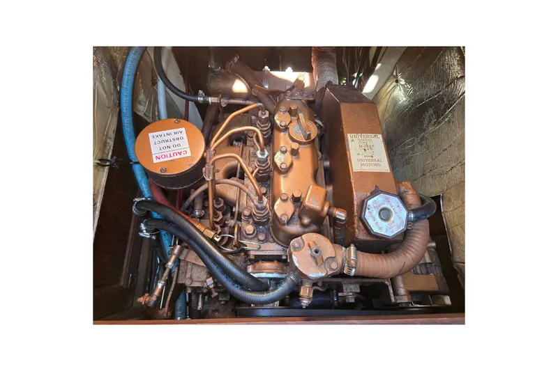 Slide: The Image of Engine of a 1989 Catalina 34 sailboat, featuring Universal Motors components. - 30