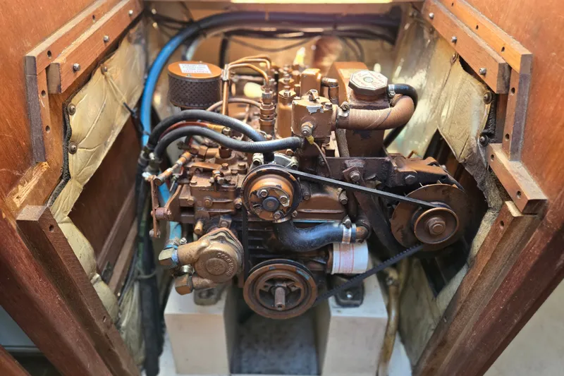 Slide: The Image of Engine compartment of a 1989 Catalina 34 sailboat, showcasing detailed mechanical components. - 31