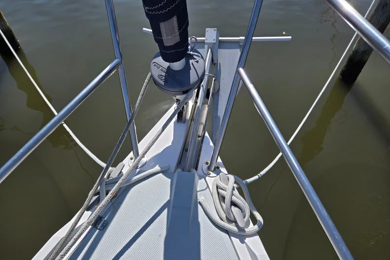 Slide: The Image of Bow of a 1989 Catalina 34 sailboat with ropes and railing in a marina. - 7