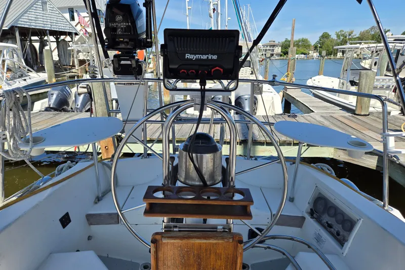 Slide: The Image of Cockpit of a 1989 Catalina 34 sailboat with navigation equipment at a marina. - 2