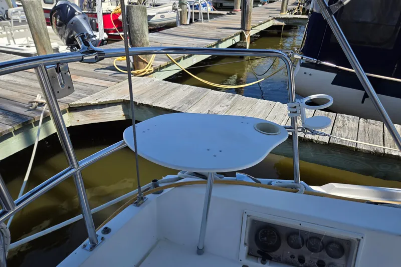Slide: The Image of Cockpit of 1989 Catalina 34 sailboat with dock view and mounted table. - 9