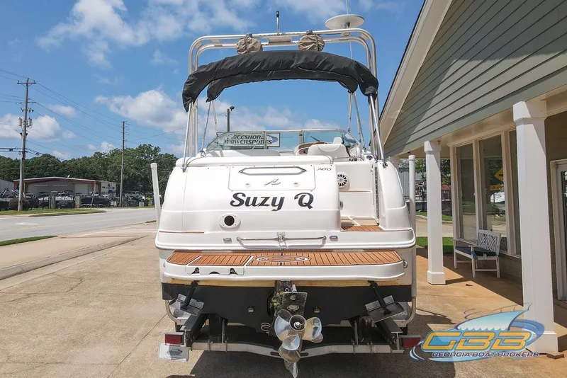 Slide: The Image of 2000 Sea Ray Sundancer 260 boat named "Suzy Q" parked outside a building. - 13