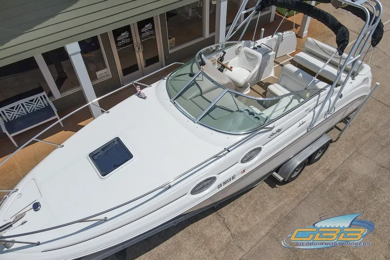 Slide: The Image of 2000 Sea Ray Sundancer 260 boat on trailer, viewed from above, parked near a building. - 20