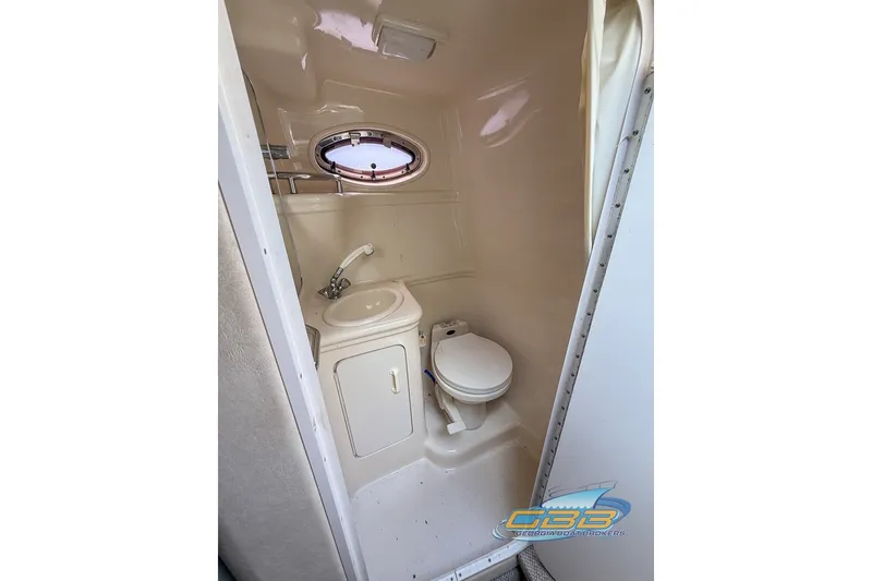 Slide: The Image of Compact bathroom in 2000 Sea Ray Sundancer 260 boat with sink and toilet. - 8