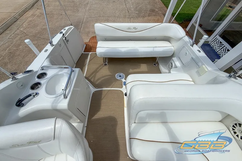 Slide: The Image of Interior of a 2000 Sea Ray Sundancer 260 boat with white seating and amenities. - 4