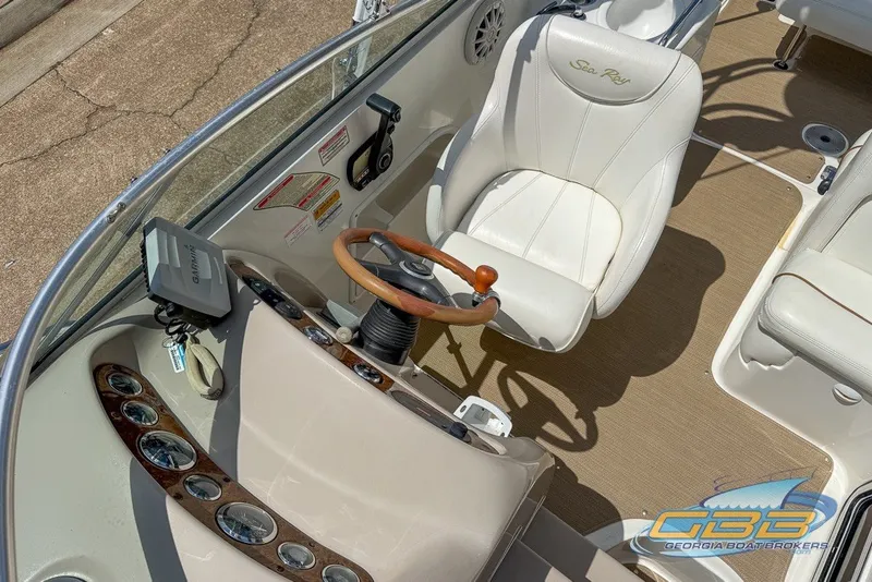 Slide: The Image of 2000 Sea Ray Sundancer 260 cockpit with steering wheel and white captain's chair. - 36