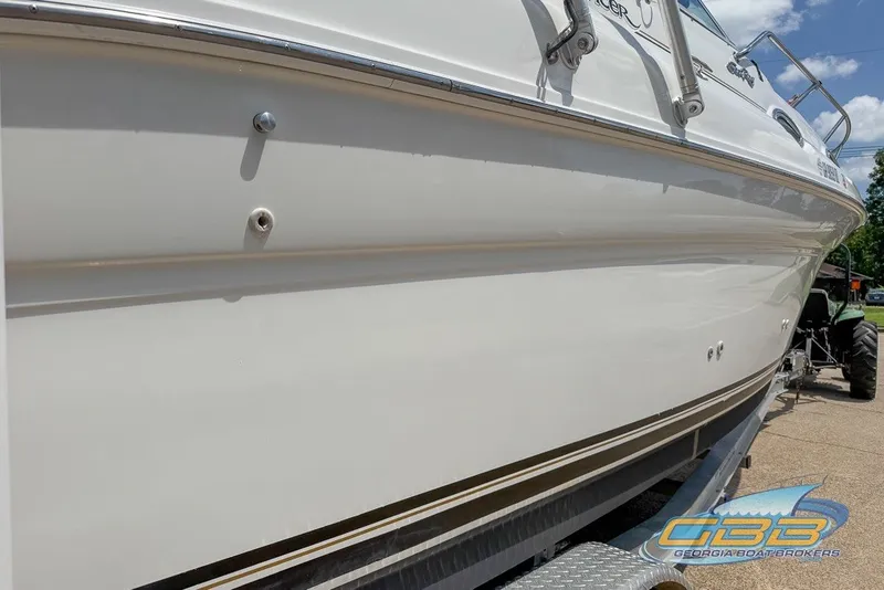 Slide: The Image of 2000 Sea Ray Sundancer 260 boat on trailer, side view, clear sky background. - 30