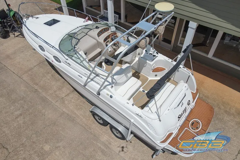 Slide: The Image of 2000 Sea Ray Sundancer 260 boat on trailer, aerial view, docked near building. - 17