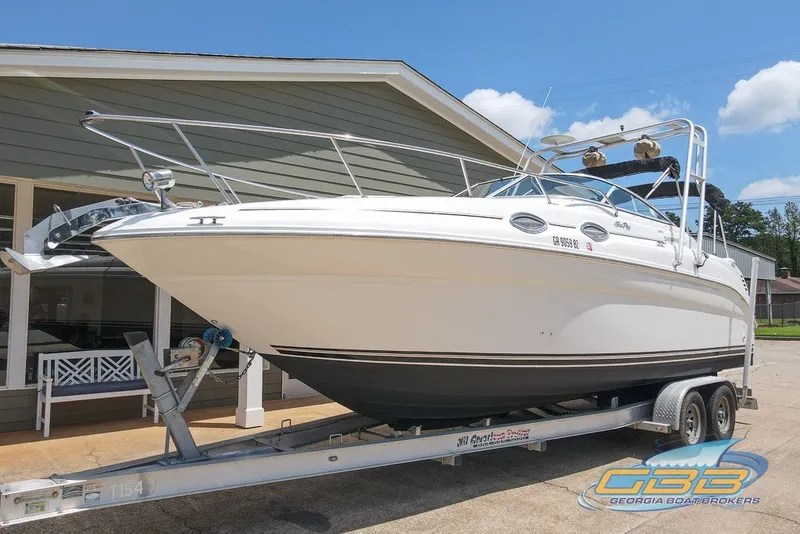 Slide: The Image of 2000 Sea Ray Sundancer 260 on trailer, displayed outdoors under clear blue sky. - 15