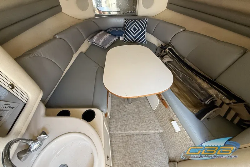 Slide: The Image of Interior of 2000 Sea Ray Sundancer 260 with seating, table, and sink. - 7