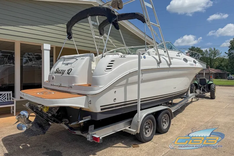 Slide: The Image of 2000 Sea Ray Sundancer 260 boat on trailer, displayed outdoors under clear sky. - 31