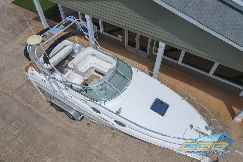 Slide: The Image of 2000 Sea Ray Sundancer 260 boat on trailer, aerial view, parked near building. - 16