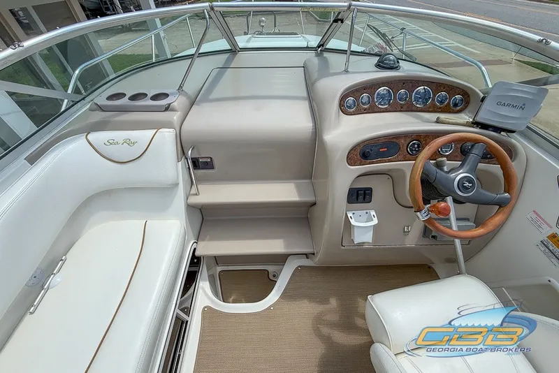 Slide: The Image of Interior view of 2000 Sea Ray Sundancer 260 boat cockpit with steering wheel and controls. - 24