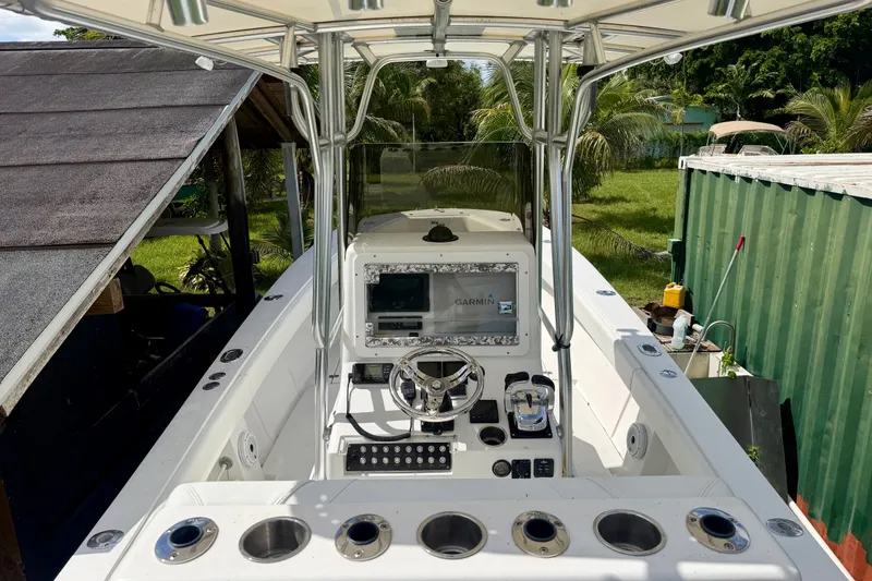 Slide: The Image of 2001 SeaVee 290B boat cockpit with Garmin navigation, surrounded by lush greenery. - 12