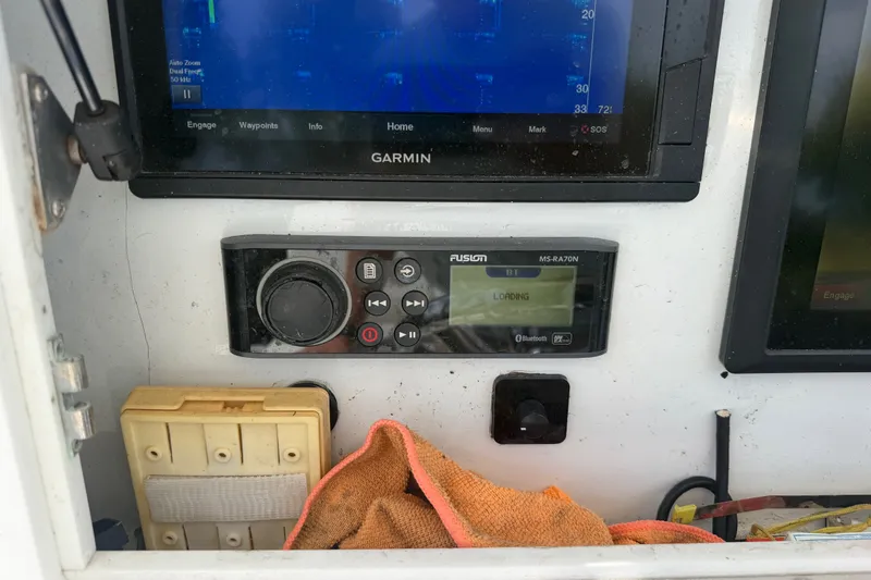 Slide: The Image of Garmin and Fusion MS-RA70N electronics on 2001 SeaVee 290B boat dashboard. - 9