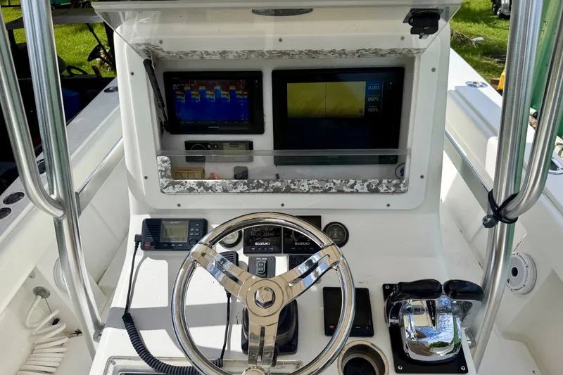 Slide: The Image of 2001 SeaVee 290B boat dashboard with steering wheel, navigation screens, and controls. - 5