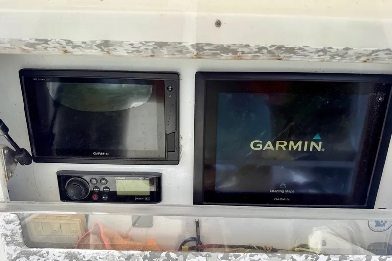 Slide: The Image of Garmin navigation system on 2001 SeaVee 290B boat dashboard, featuring GPS and audio controls. - 10