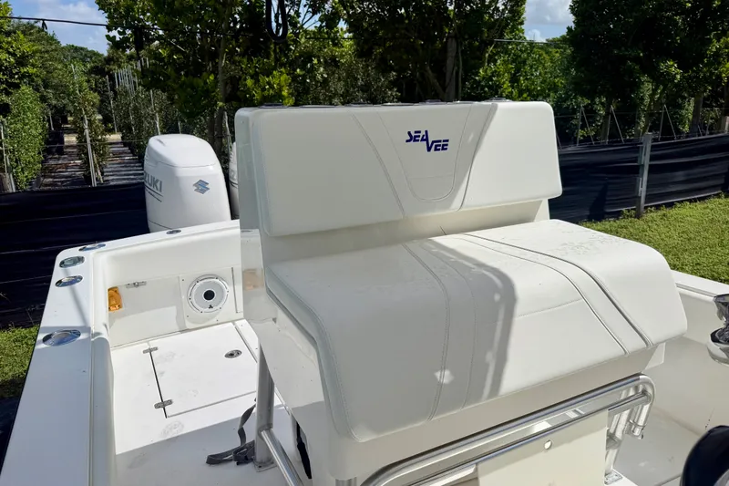 Slide: The Image of 2001 SeaVee 290B boat with Suzuki engine, featuring white seating and lush greenery backdrop. - 14