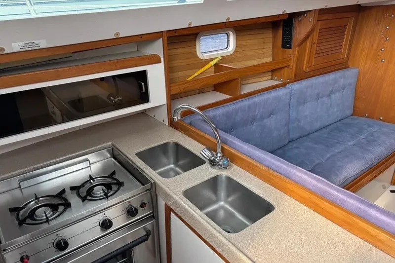 Slide: The Image of Interior of 1995 Catalina 30 MkIII yacht with kitchen and seating area. - 4